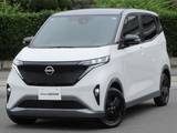 日産 サクラ X 90周年記念車 展示試乗車UP　　20Kw　Mナビ　AVM